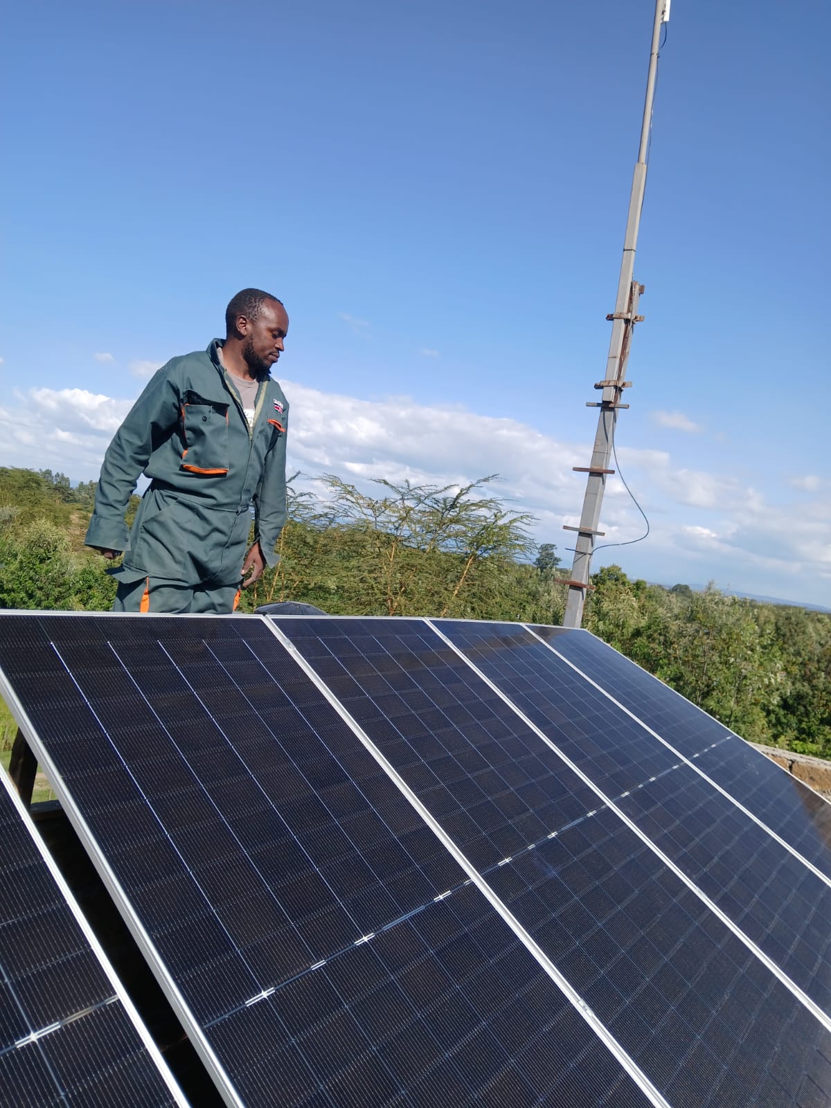 Technician installing solar panels in Kenya